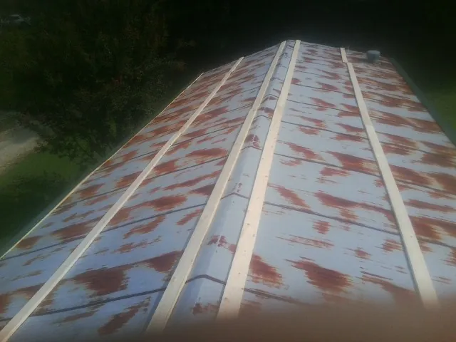 Rusted metal roof panels with new wood purlins before replacement — Storm Damage Roof Repair in Graniteville by Roofing Brothers