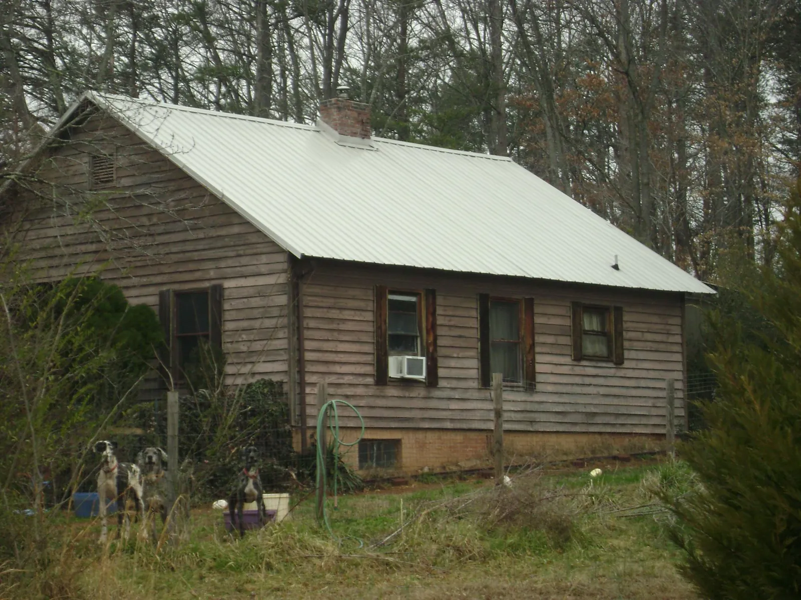 White metal roof on an old wood sided farmhouse, from a Metal Roof Installation job in Graniteville