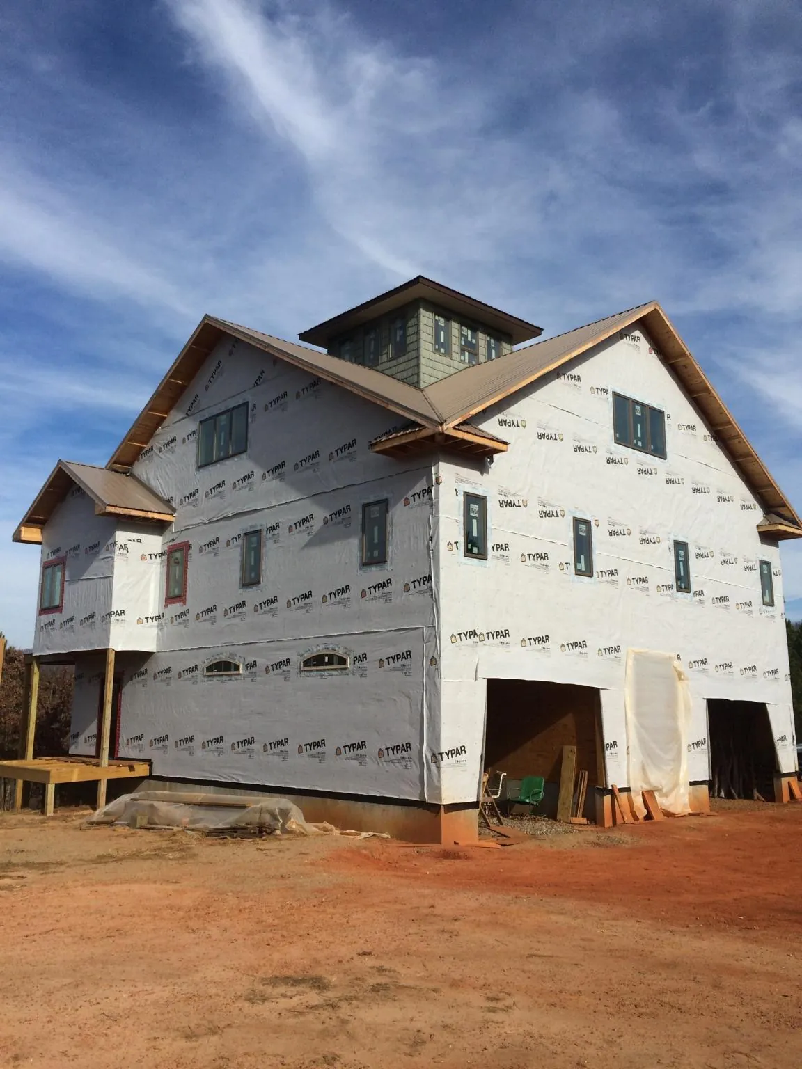 New two story house under construction with a cupola and gabled roofs in Graniteville